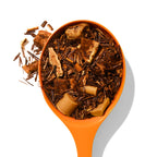 Caramel Apple loose leaf tea in an orange spoon with apple pieces