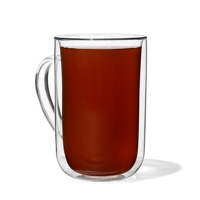 Glass mug of prepared Caramel Apple tea with a deep amber colour