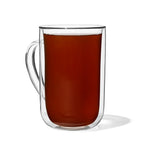 Glass mug of prepared Caramel Apple tea with a deep amber colour